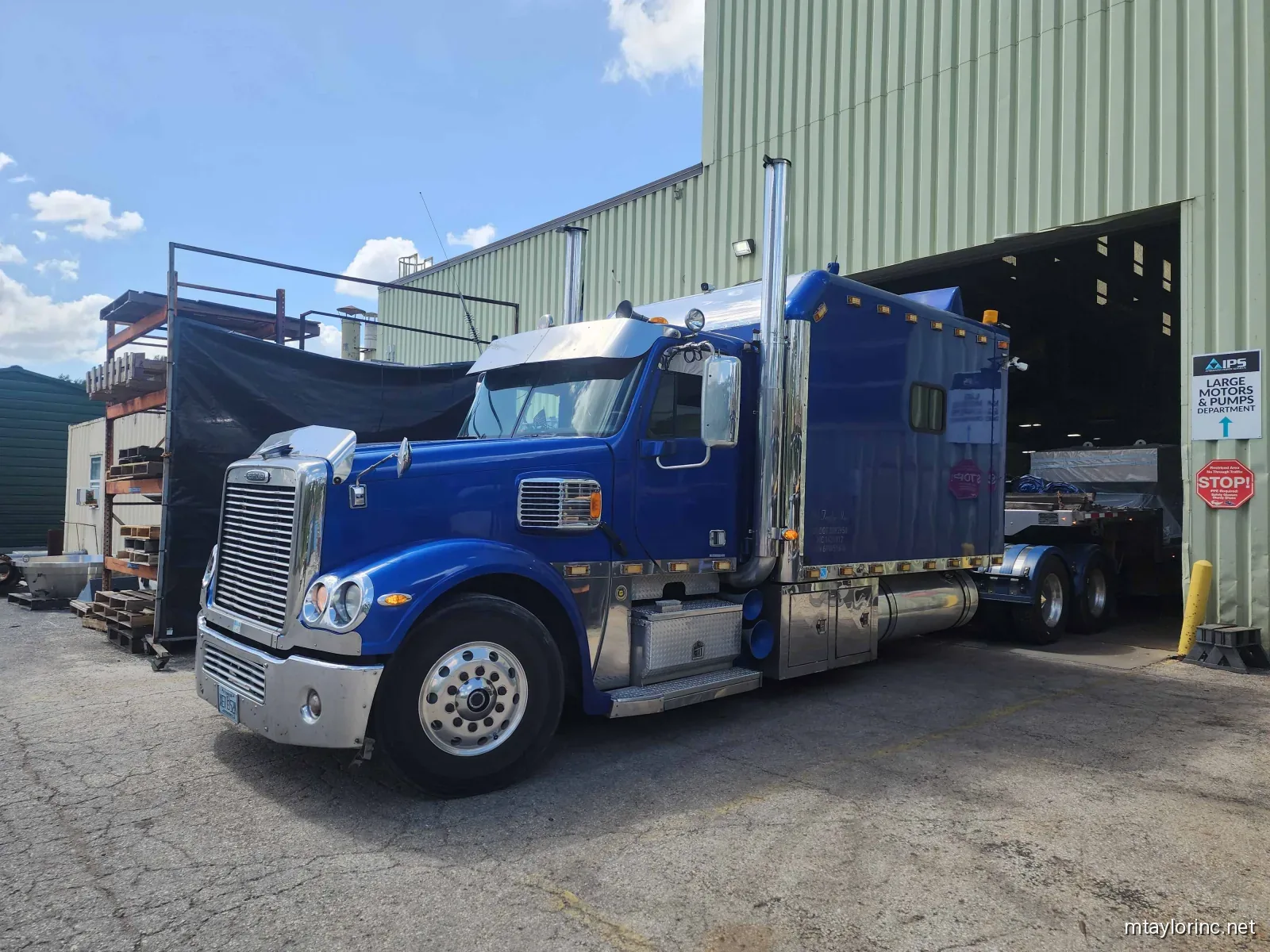 M Taylor Inc Freightliner tractor at industrial loading dock between hauls