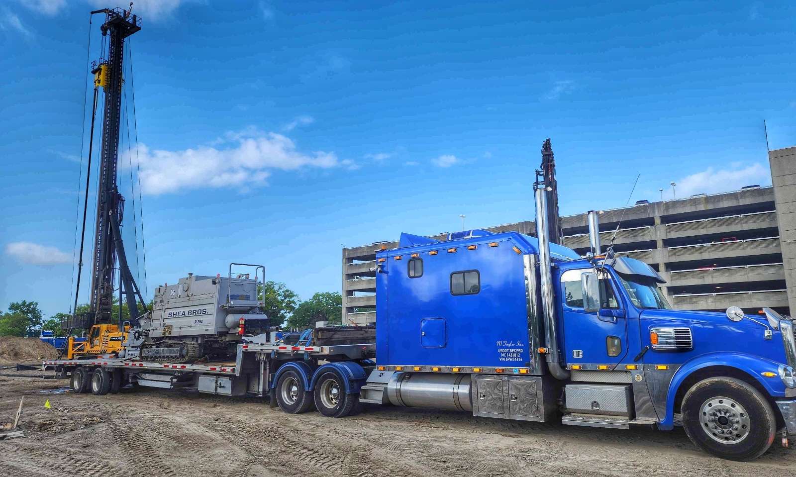Heavy machinery hauled on stepdeck trailer in Fort Lauderdale Broward County by M Taylor Inc
