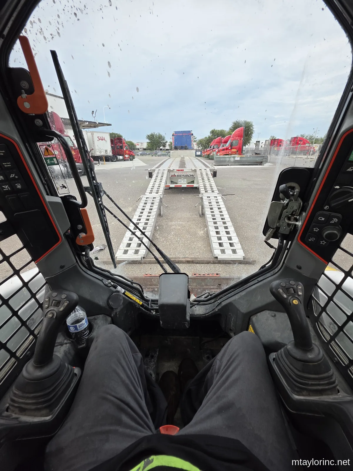 M Taylor Inc owner-operator self-loading a skid steer and excavator onto stepdeck trailer in Jacksonville Florida