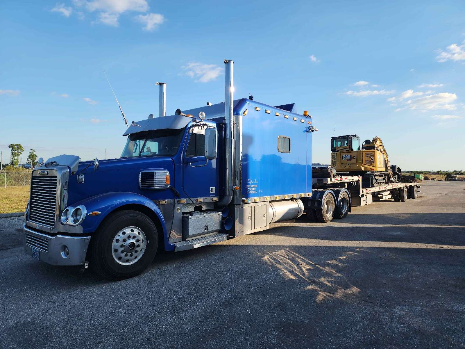 Excavator transported on stepdeck trailer in Orlando Orange County Florida