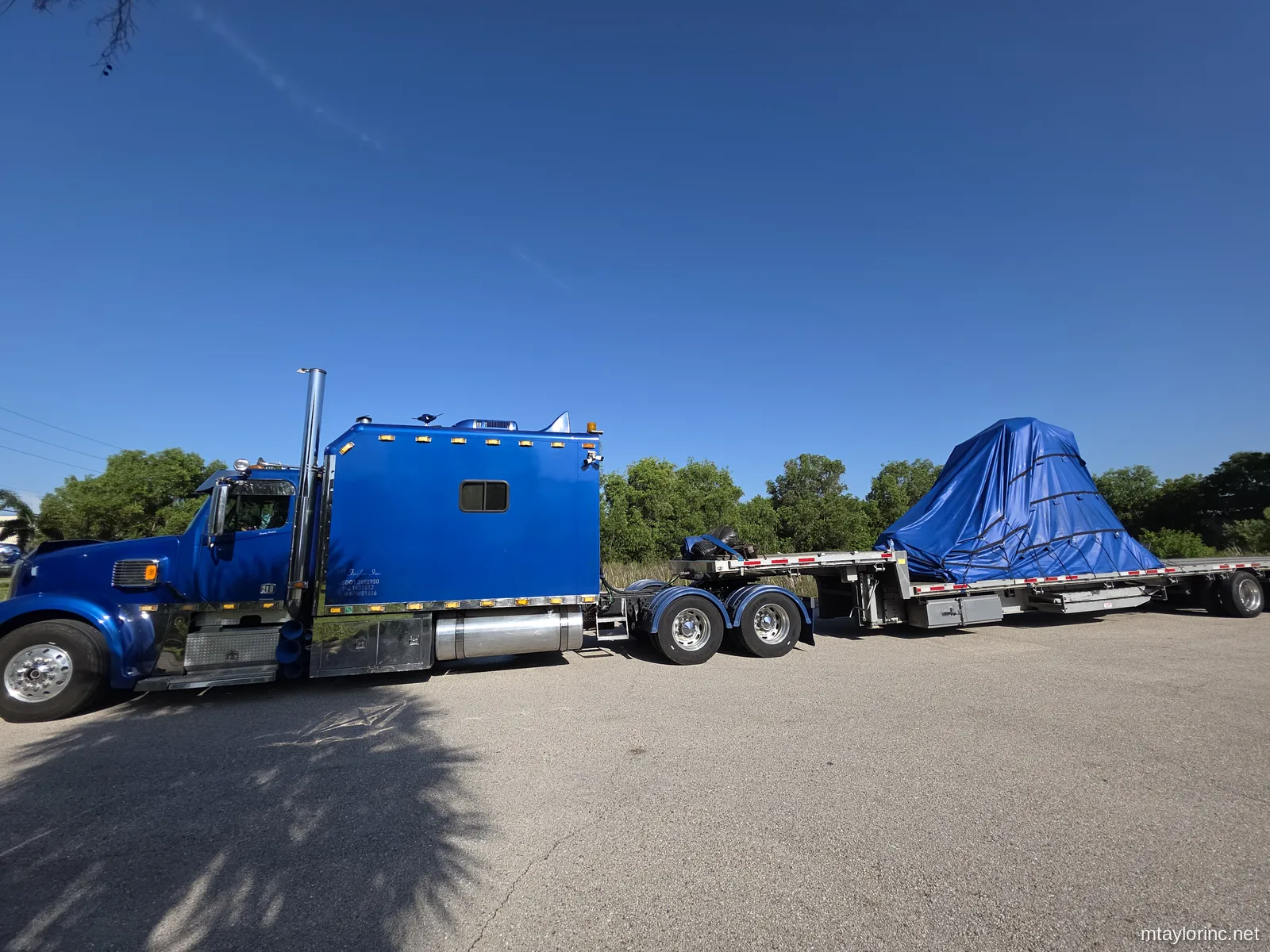 Heavy hydraulic industrial press tarped and hauled on stepdeck from Fort Myers Lee County Florida to Orlando by M Taylor Inc