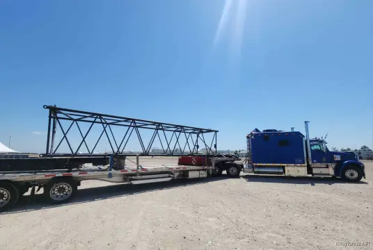 Crane components secured on stepdeck trailer