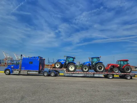 Farm tractors hauled for port export